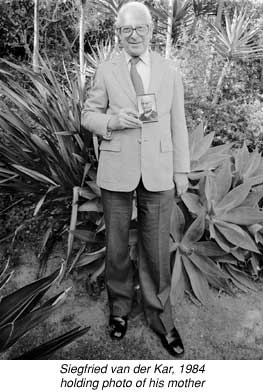 Photograph of Siegfried van der Kar holding picture of his mother